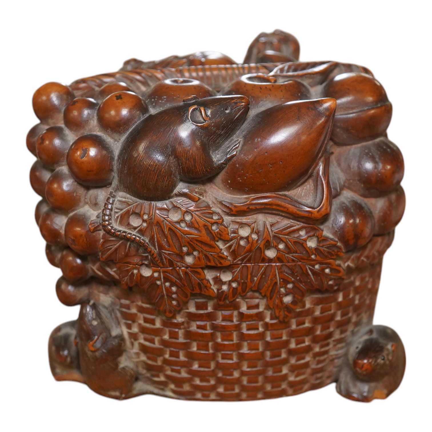 A Japanese boxwood koro and cover, Meiji period, modelled as a basket of fruit with mice, signed to the base, 9cm wide. Condition - fair to good, some chipping